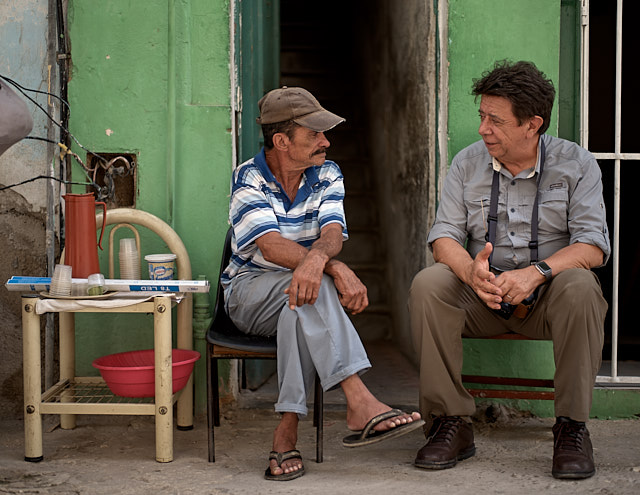 Carlos Bertoni from Brazil having a chat with a local who sells coffee outside his house. Leica M10-P with Leica 50mm Summilux-M ASPH f/1.4 BC. © Thorsten Overgaard. 